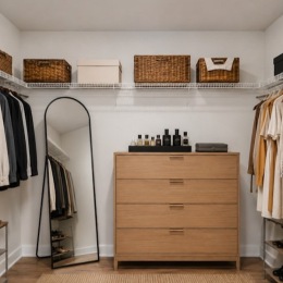 a closet with clothes, a dresser and a mirror